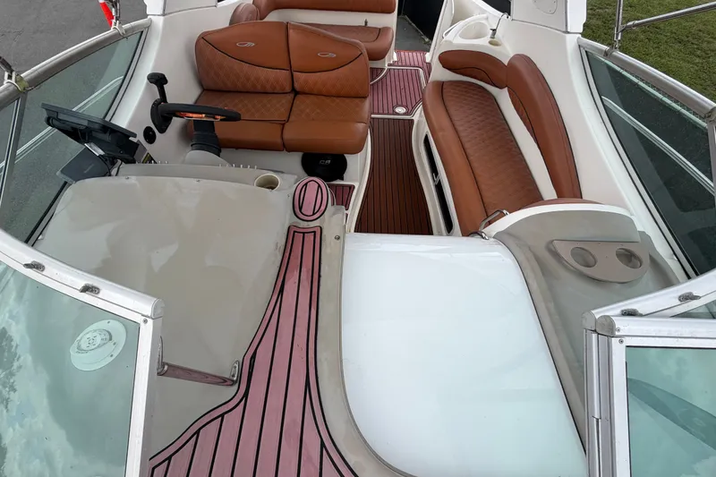 Slide: The Image of 2003 Maxum 2900 SE boat interior with brown leather seating and wood accents. - 49