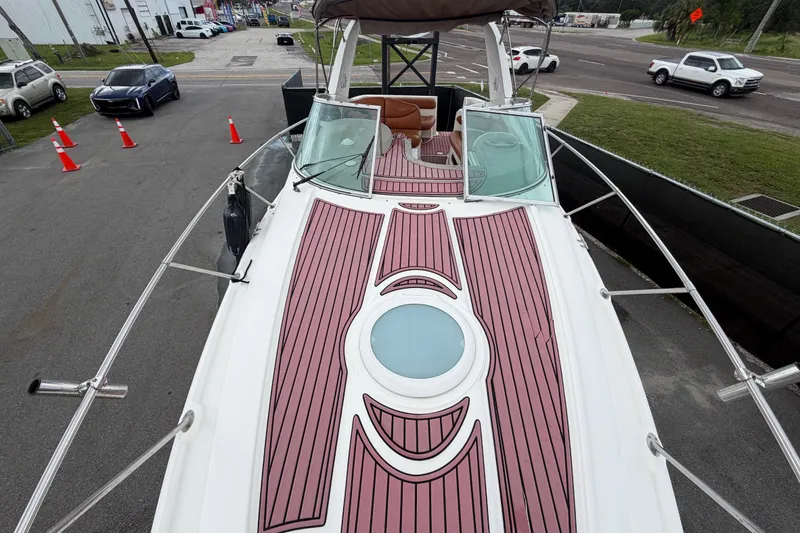 Slide: The Image of 2003 Maxum 2900 SE boat with stylish deck design, parked near a road. - 47