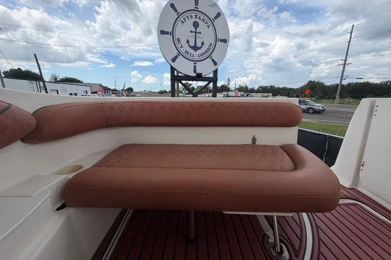 Slide: The Image of 2003 Maxum 2900 SE boat with brown leather seating and nautical decor. - 89