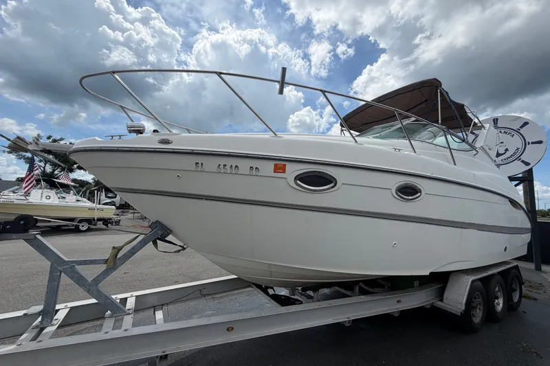 Slide: The Image of 2003 Maxum 2900 SE boat on trailer under cloudy sky. - 12