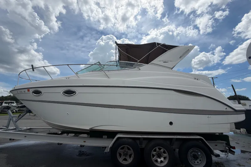 Slide: The Image of 2003 Maxum 2900 SE boat on trailer under cloudy sky. - 11