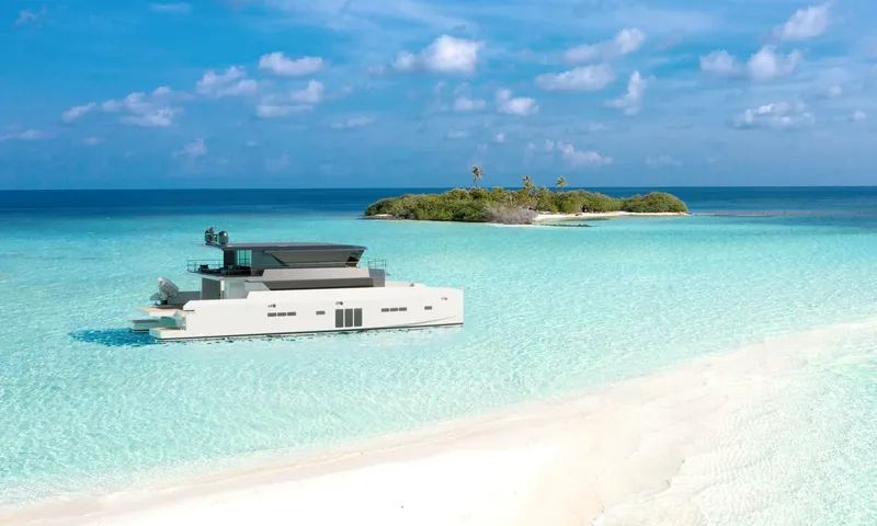 Slide: The Image of A modern Archipelago A-80 Expedition yacht in turquoise waters near a small island, 2025 model. - 2