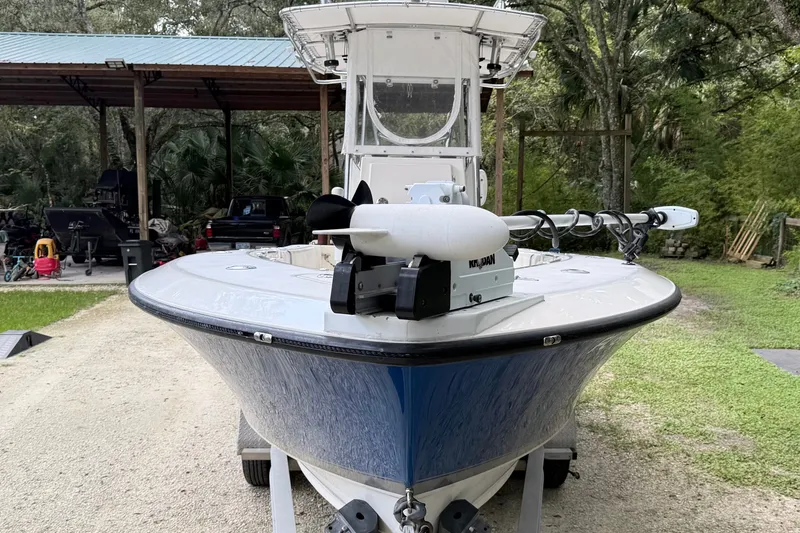 Slide: The Image of 2007 Contender 23 Tournament boat with trolling motor, parked outdoors on gravel. - 6