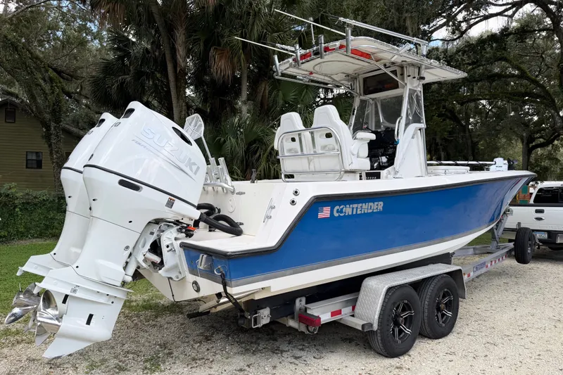 Slide: The Image of 2007 Contender 23 Tournament boat with Suzuki outboard engine on a trailer. - 2