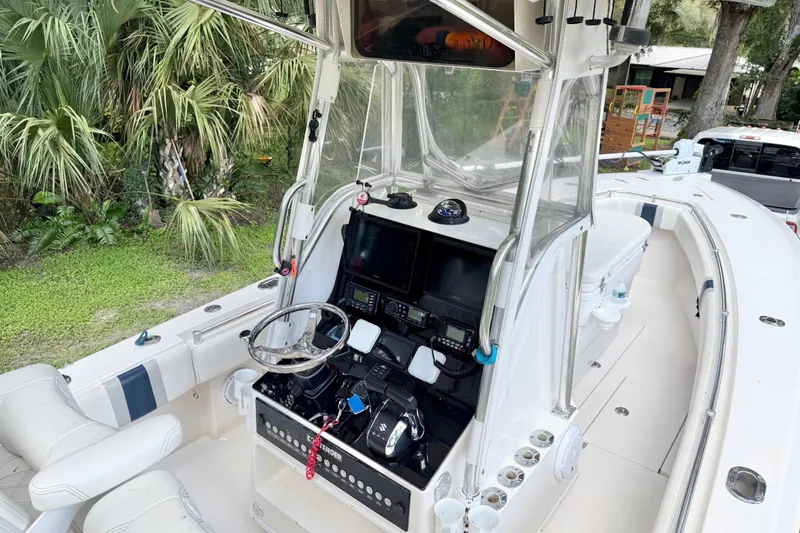 Slide: The Image of 2007 Contender 23 Tournament boat cockpit with steering wheel and navigation equipment. - 13