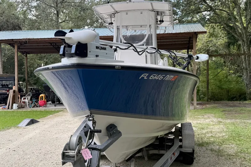 Slide: The Image of 2007 Contender 23 Tournament boat on trailer, parked outdoors near a shed. - 8