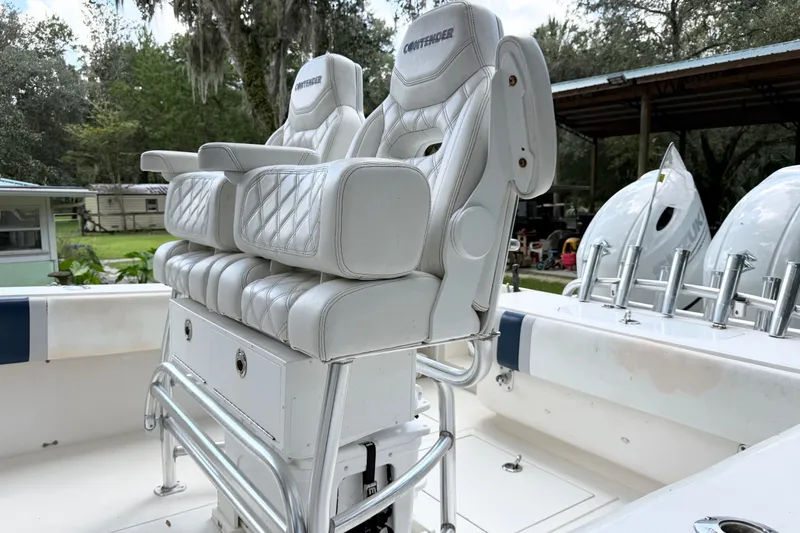 Slide: The Image of 2007 Contender 23 Tournament boat with white cushioned seats and rod holders. - 11