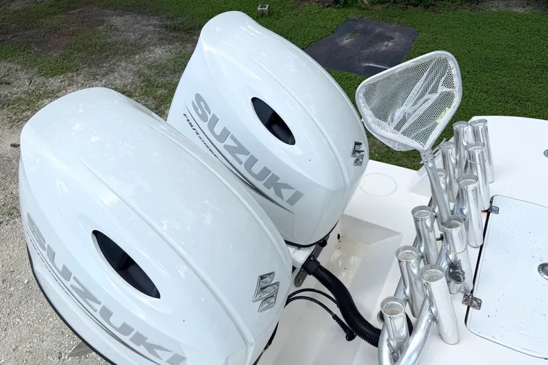 Slide: The Image of Twin Suzuki outboard motors on a 2007 Contender 23 Tournament boat. - 16