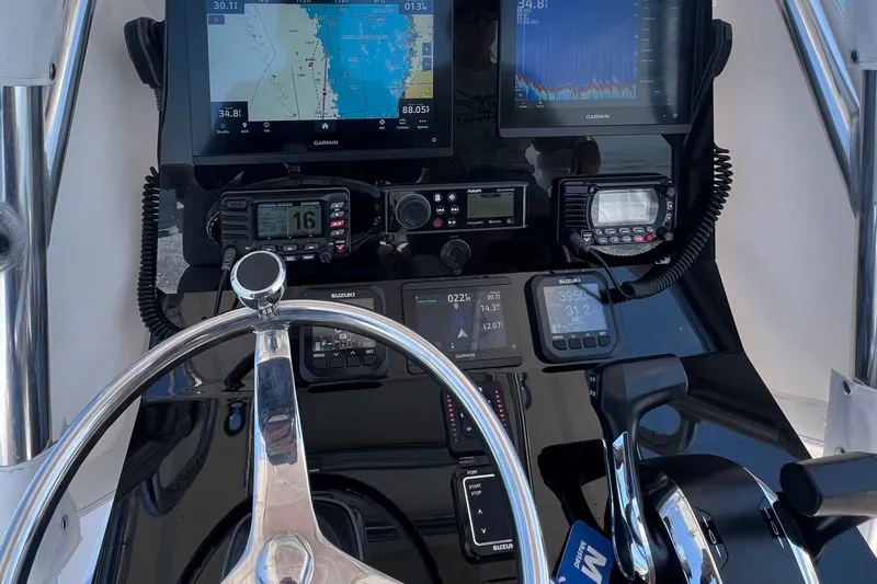 Slide: The Image of Steering console of a 2007 Contender 23 Tournament boat with navigation equipment. - 18