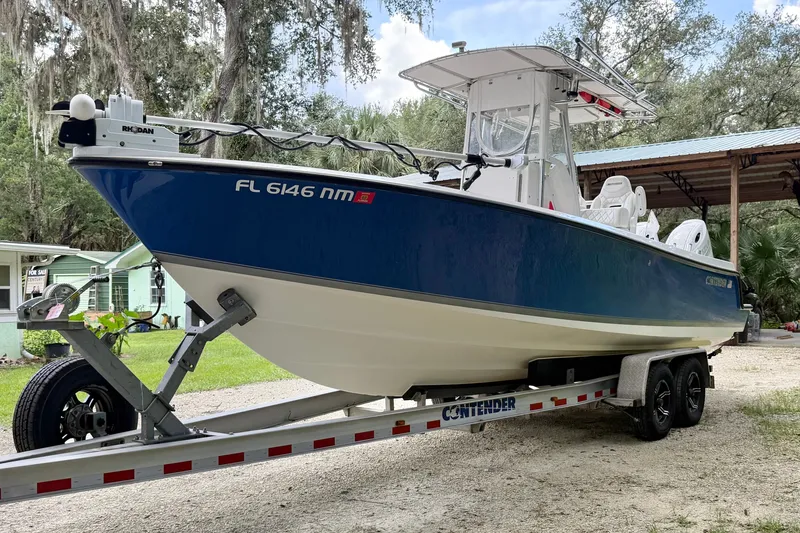 Slide: The Image of 2007 Contender 23 Tournament boat on trailer, parked outdoors. - 5