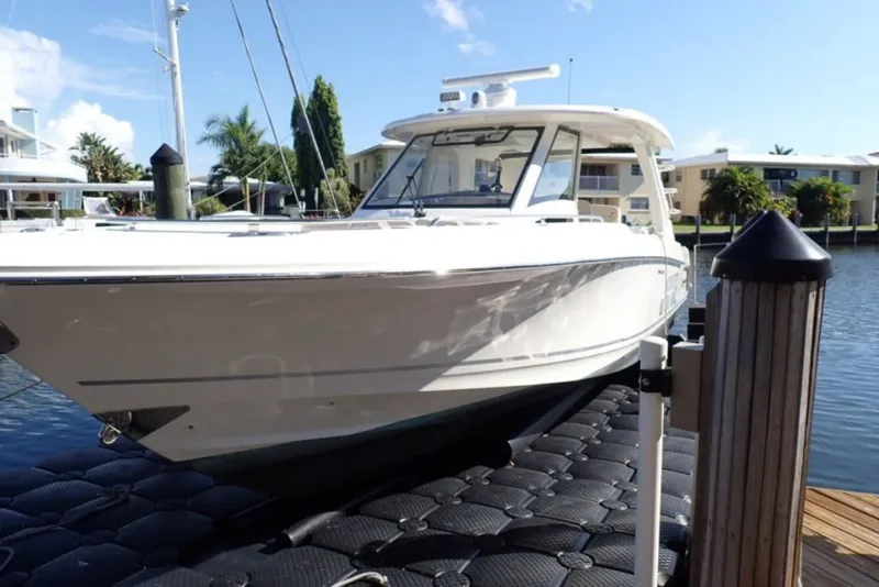 Slide: The Image of 2018 Boston Whaler 350 Realm boat docked on a sunny day. - 0
