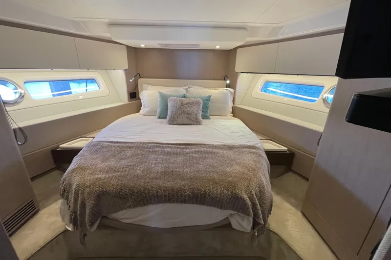 Slide: The Image of Luxurious guest bedroom interior of 2023 Azimut Fly 50 yacht with elegant bedding and porthole windows. - 10