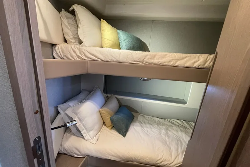 Slide: The Image of 2023 Azimut Fly 50 yacht interior with cozy bunk beds and stylish pillows. - 11