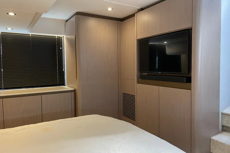 Slide: The Image of Luxurious master bedroom of 2023 Azimut Fly 50 yacht with modern wood paneling and TV. - 15