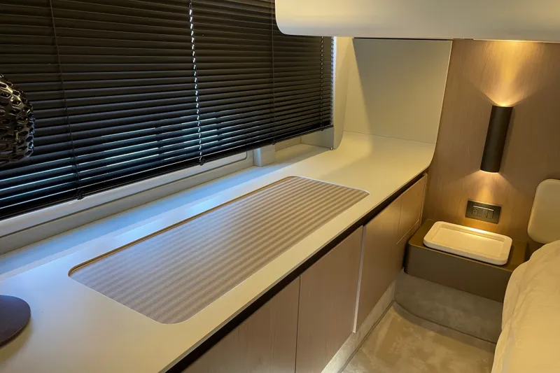 Slide: The Image of Luxurious master bedroom of 2023 Azimut Fly 50 yacht with modern design and ambient lighting. - 13