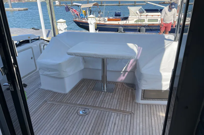 Slide: The Image of 2023 Azimut Fly 50 yacht deck with covered seating and table. - 19