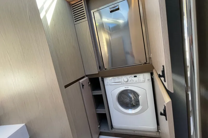 Slide: The Image of Laundry area in 2023 Azimut Fly 50 yacht with washer and storage cabinets. - 7