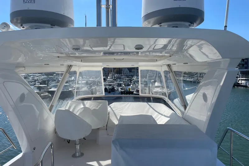 Slide: The Image of 2023 Azimut Fly 50 yacht flybridge with marina view, featuring sleek design and modern amenities. - 2