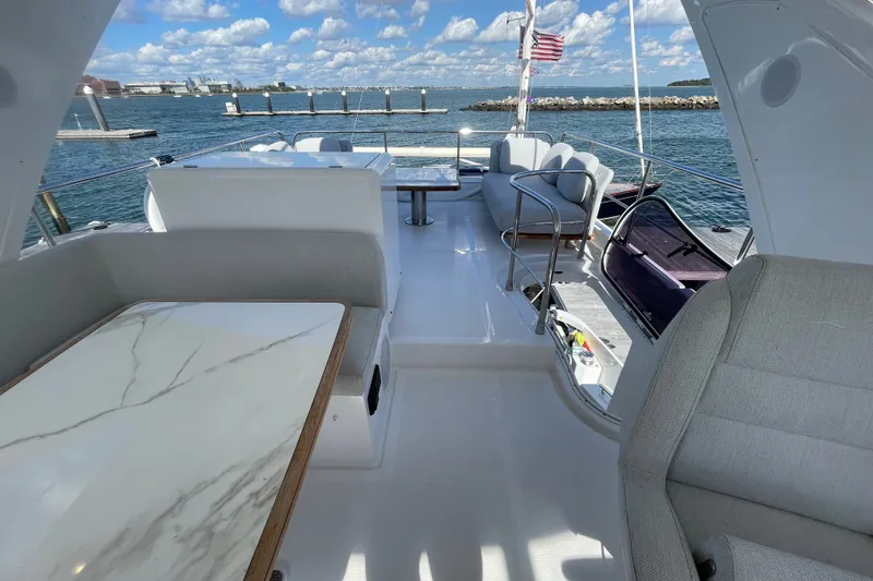 Slide: The Image of Flybridge dining and seating looking aft. - 52