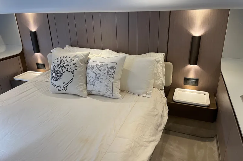 Slide: The Image of Luxurious master bedroom interior of 2023 Azimut Fly 50 yacht with elegant lighting and cozy bedding. - 14