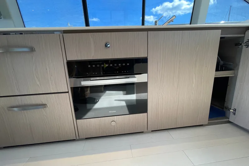 Slide: The Image of Galley up with Meile oven and convection cooktop. Freezer and reefer to left. - 21