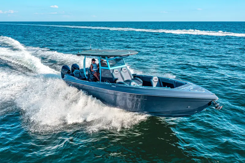 Slide: The Image of 2025 Glasstream 32 GSX boat cruising on open water, creating waves. - 9