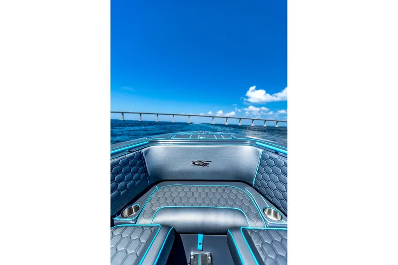 Slide: The Image of 2025 Glasstream 32 GSX boat interior with blue accents, ocean view, and bridge in background. - 2