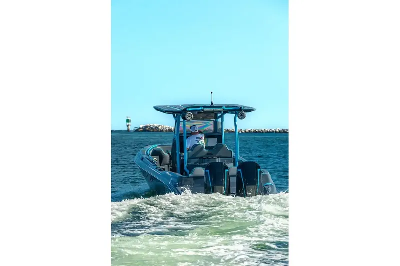 Slide: The Image of 2025 Glasstream 32 GSX boat cruising on open water, rear view. - 12