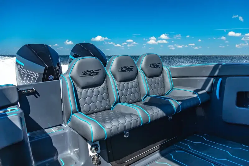 Slide: The Image of 2025 Glasstream 32 GSX boat interior with stylish seating and dual engines on open water. - 4