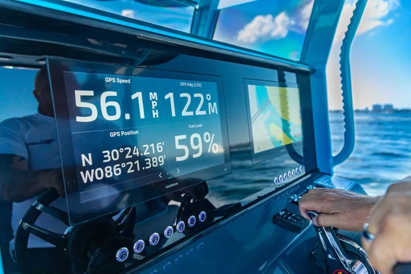 Slide: The Image of 2025 Glasstream 32 GSX dashboard displaying GPS speed, heading, and fuel level on open water. - 5