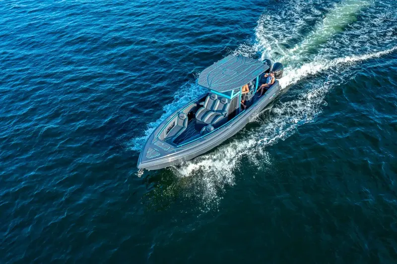 Slide: The Image of 2025 Glasstream 32 GSX boat cruising on open water, aerial view. - 10