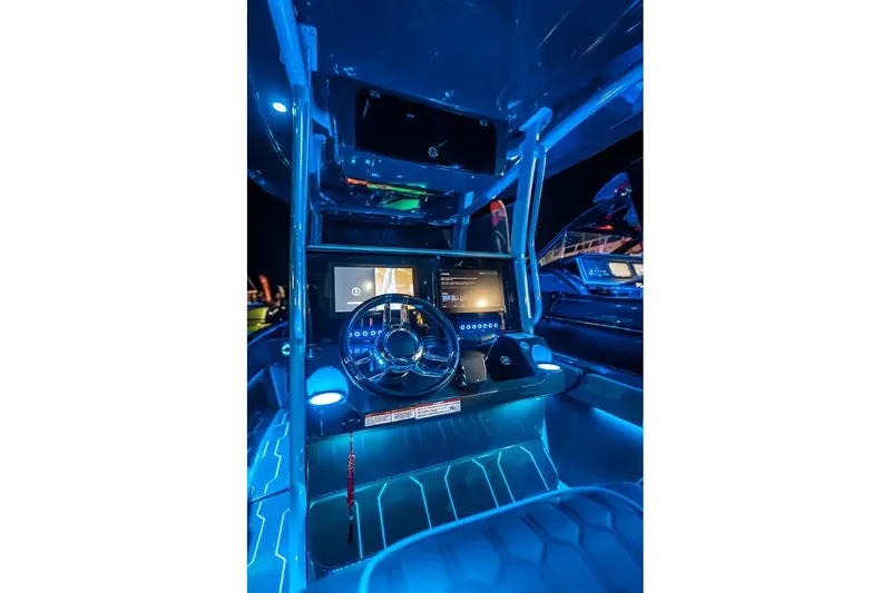 Slide: The Image of 2025 Glasstream 32 GSX boat cockpit with illuminated dashboard and modern steering wheel. - 3