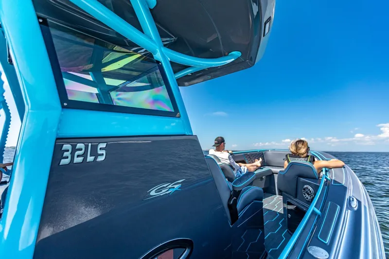 Slide: The Image of 2025 Glasstream 32 GSX boat cruising on open water under clear blue skies. - 6