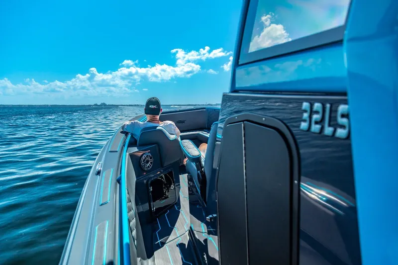 Slide: The Image of 2025 Glasstream 32 GSX boat cruising on open water under clear blue skies. - 8