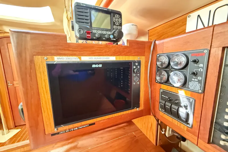 Slide: The Image of Navigation equipment and control panel inside a 2000 Hunter 460 sailboat cabin. - 44