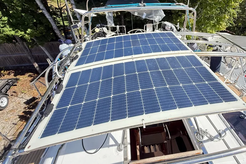Slide: The Image of Solar panels on a 2000 Hunter 460 yacht, surrounded by trees. - 18
