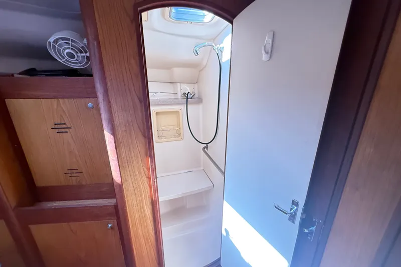 Slide: The Image of Interior of a 2000 Hunter 460 yacht showing a compact bathroom with shower. - 60