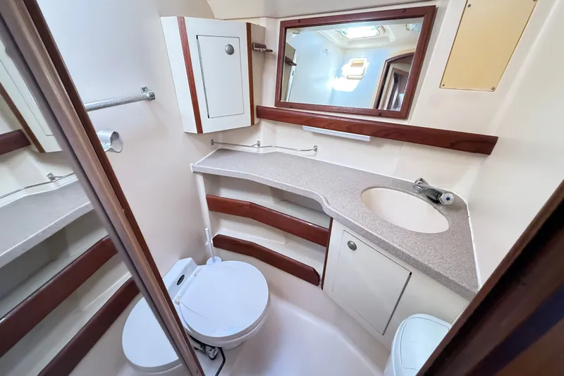 Slide: The Image of Compact bathroom in a 2000 Hunter 460 yacht with sink, toilet, and mirror. - 58
