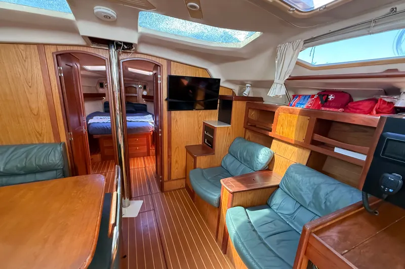 Slide: The Image of Interior of a 2000 Hunter 460 yacht with wood finish and seating area. - 51