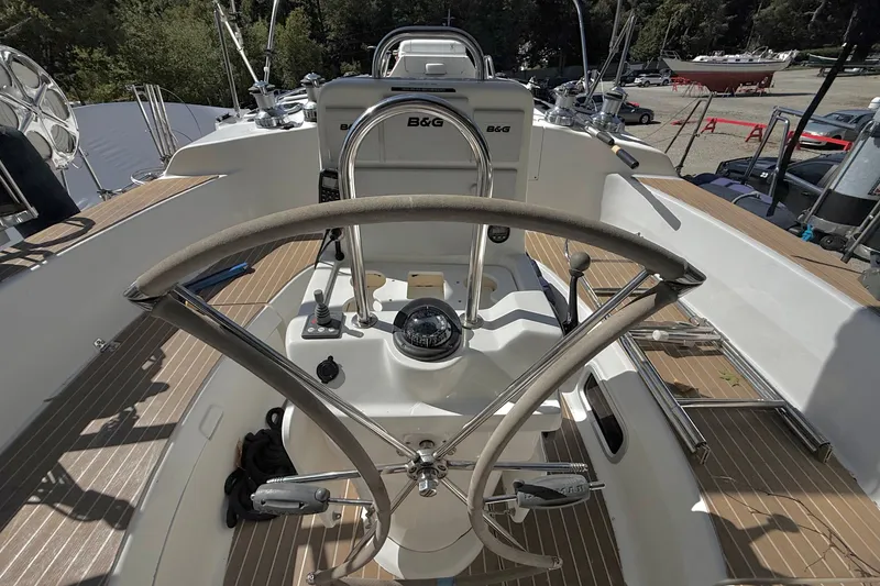 Slide: The Image of Steering wheel and cockpit of a 2000 Hunter 460 sailboat, featuring B&G navigation equipment. - 19