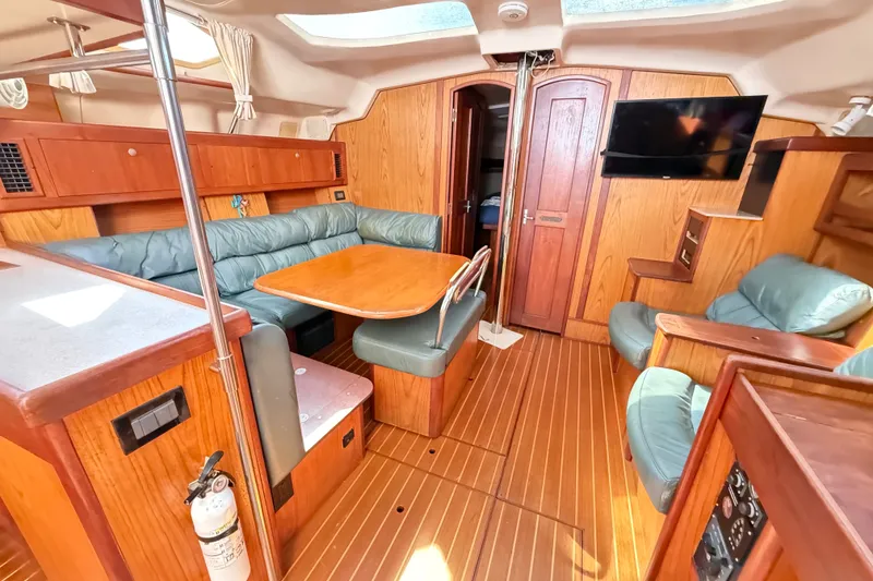 Slide: The Image of Interior of a 2000 Hunter 460 yacht with wood finish and seating area. - 49