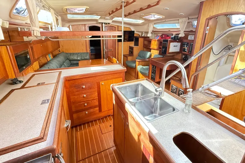 Slide: The Image of Interior of a 2000 Hunter 460 yacht with wooden cabinetry and modern amenities. - 30