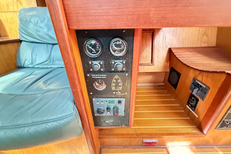 Slide: The Image of Control panel of a 2000 Hunter 460 yacht with gauges and switches. - 46