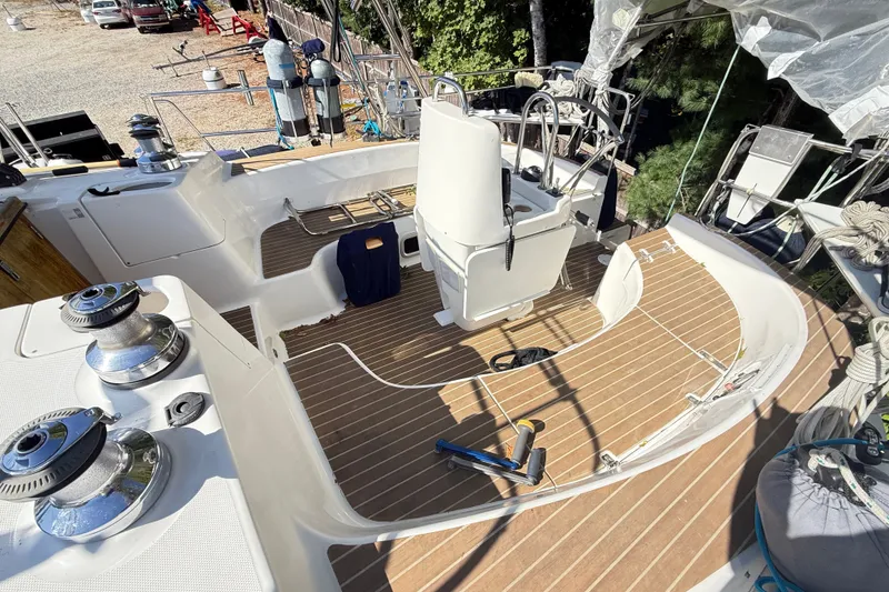 Slide: The Image of Cockpit of a 2000 Hunter 460 sailboat with wooden deck and steering wheel. - 15