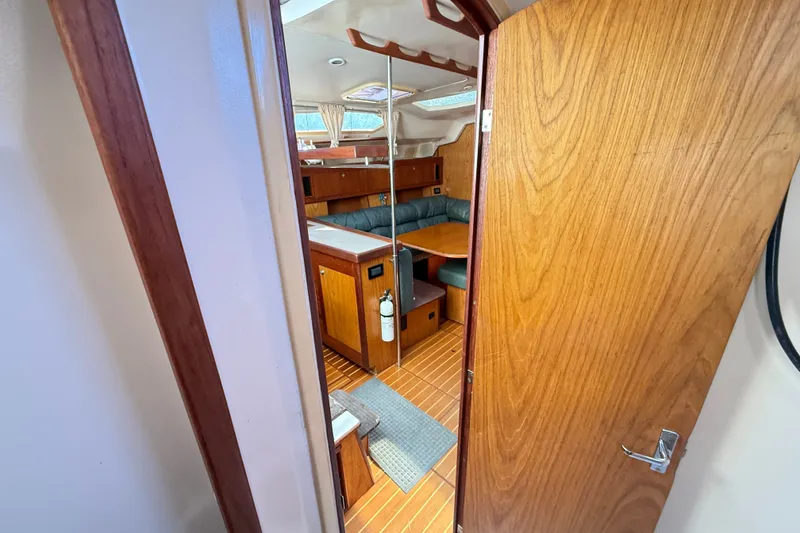 Slide: The Image of Interior view of a 2000 Hunter 460 sailboat with wooden furnishings and seating area. - 40