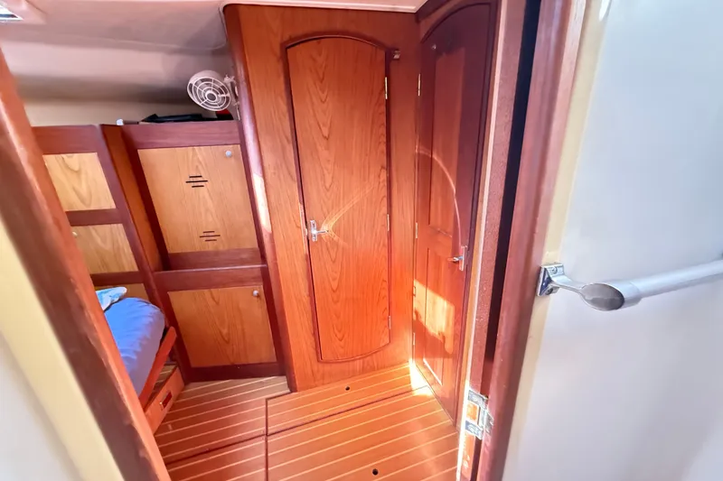 Slide: The Image of Interior of a 2000 Hunter 460 yacht with wooden cabinetry and flooring. - 59