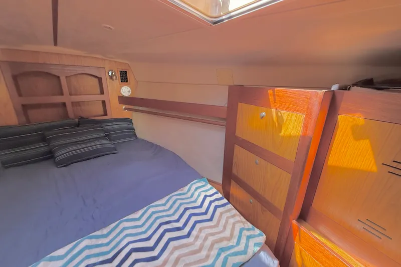 Slide: The Image of Cozy cabin interior of a 2000 Hunter 460 sailboat with wooden furnishings. - 55