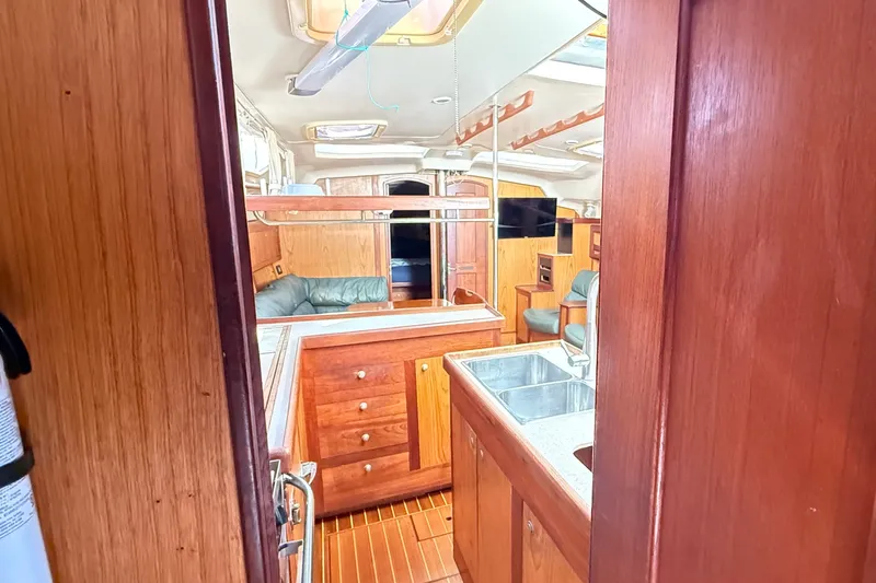 Slide: The Image of Interior of 2000 Hunter 460 yacht with wooden cabinetry and modern amenities. - 29