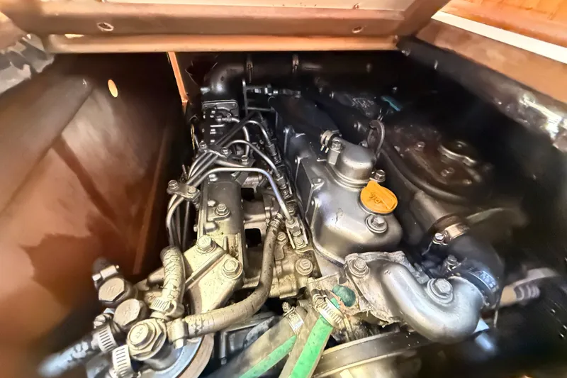 Slide: The Image of Engine compartment of a 2000 Hunter 460 sailboat, showcasing mechanical components. - 68