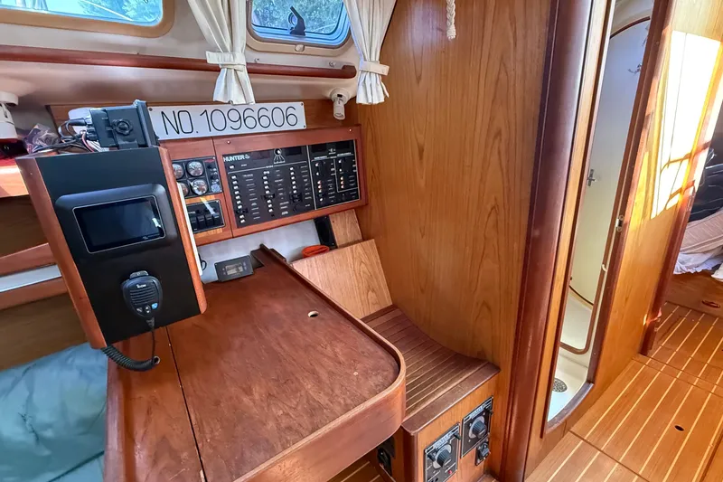 Slide: The Image of Interior of a 2000 Hunter 460 sailboat with navigation panel and wooden cabinetry. - 42